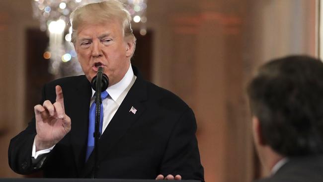 Donald Trump speaks as CNN's Jim Acosta, standing at right, listens, during the news conference. Picture: Evan Vucci/AP