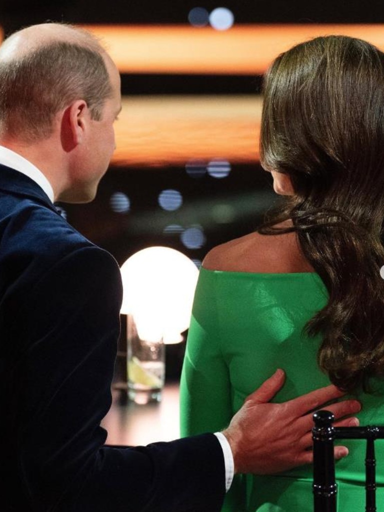 Prince William places his hand on the Princess of Wales's back during their Boston visit.