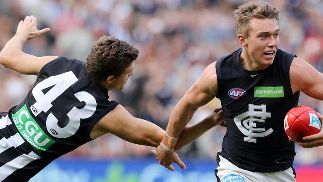 Patrick Cripps brushes past Adam Oxley. Pic: Michael Klein