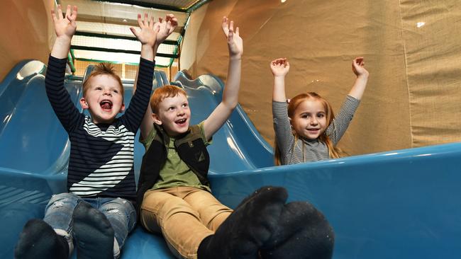 Oliver, Henry and Charlee test out the big blue slide at Myer’s Monkey Mania playground, which is opening at its Eastland store on June 2. Picture: JAMES ROSS.