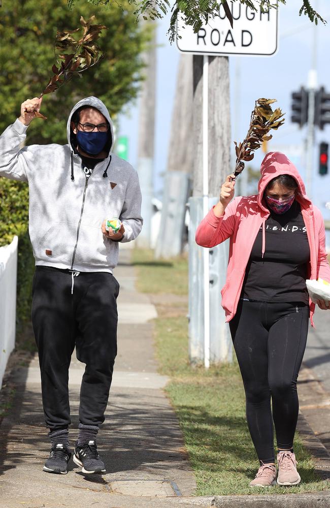 Local residents with sticks to stop the magpie from attacking them. Picture: Liam Kidston