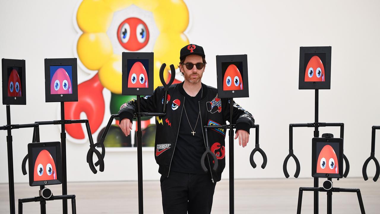 British pop artist Philip Colbert poses for photographers alongside remote-view robots that visitors can digitally control to explore 'Philip Colbert: Lobsteropolis' at the Saatchi Gallery in London. Picture: AFP