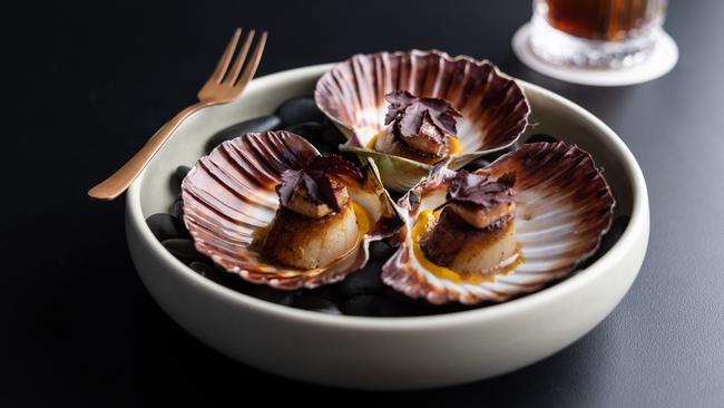 The charred scallops with carrot and ginger puree. Picture: David Kelly