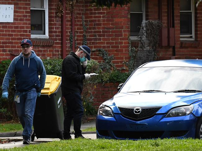 AFP officers search an apartment and these two cars in Churchill Avenue, Ascot Vale. Picture: Nicole Garmston