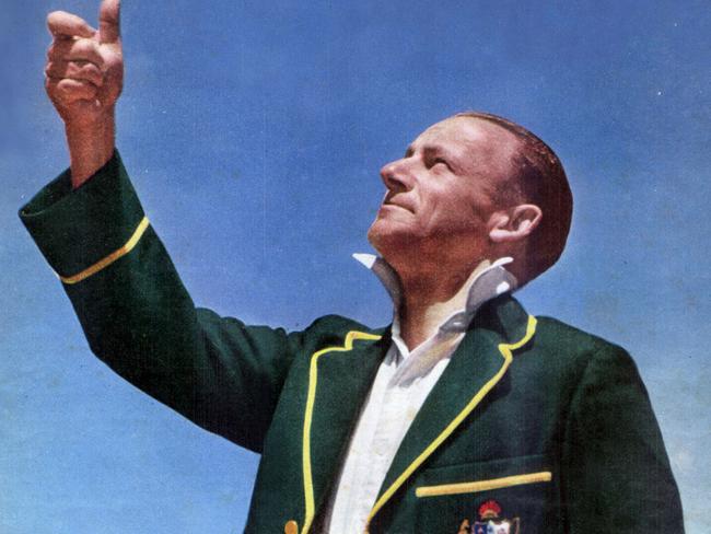 Cricketer Sir Donald (Don) Bradman wearing the Australian team 1936-37 Tour jacket, tossing coin before the start of a cricket match in Adelaide 1948. 1940s historical