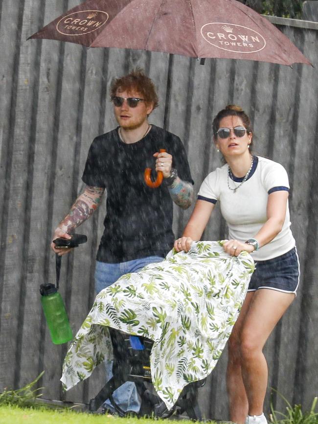 The couple were caught in a small downpour. Picture: MEDIA-MODE.COM