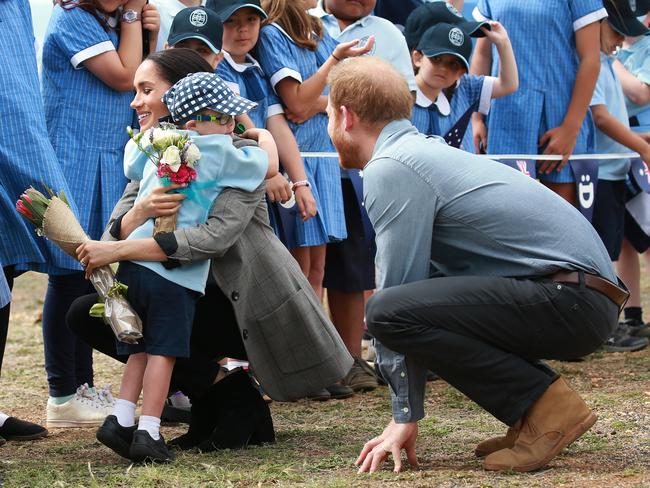 Student Luke Vincent gives Meghan flowers and a hug. Picture: Toby Zerna