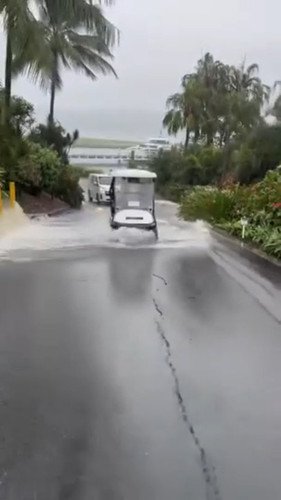 Golf cart on Hamilton Island struggles in record rain