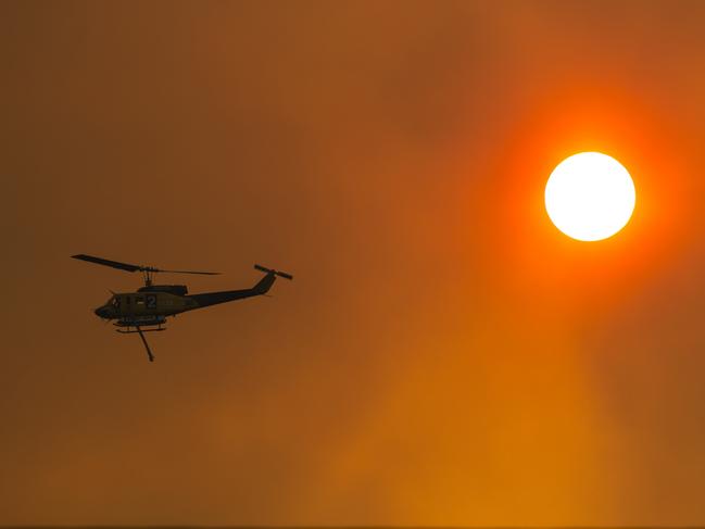 A helicopter at work in Miena in Tasmania’s Central Plateau. Picture: HEATH HOLDEN/Getty Images