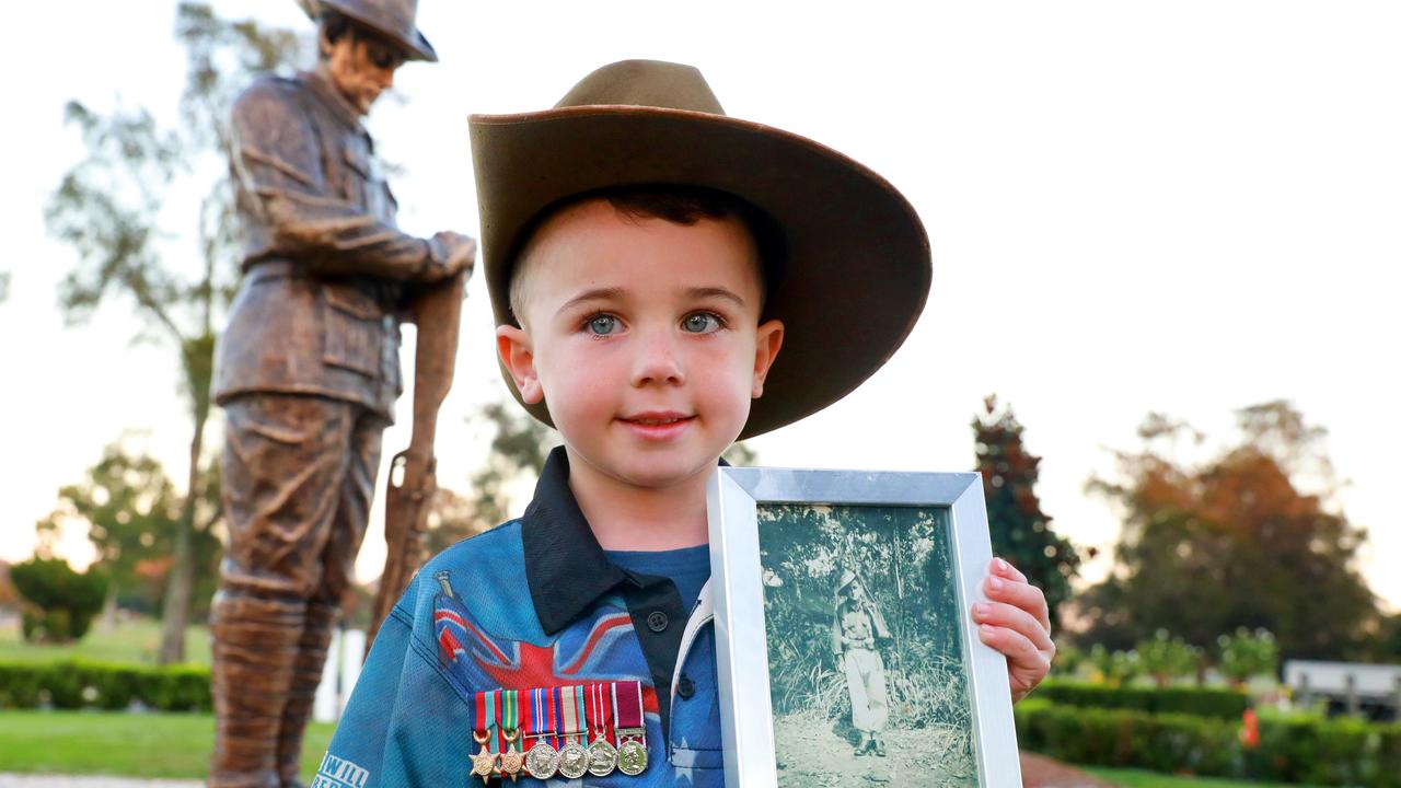 Descendant Korbin Jones, 5, holds a photo of his great-grandfather Thomas Jones at Pinegrove Memorial Park after the dawn service in Minchinbury. Picture: Angelo Velardo