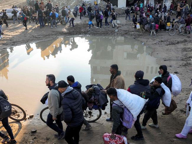 Displaced people arrive in Gaza City after crossing the crossing the Netzarim corridor from the southern Gaza Strip along Gaza's coastal al-Rashid Street. Picture: AFP