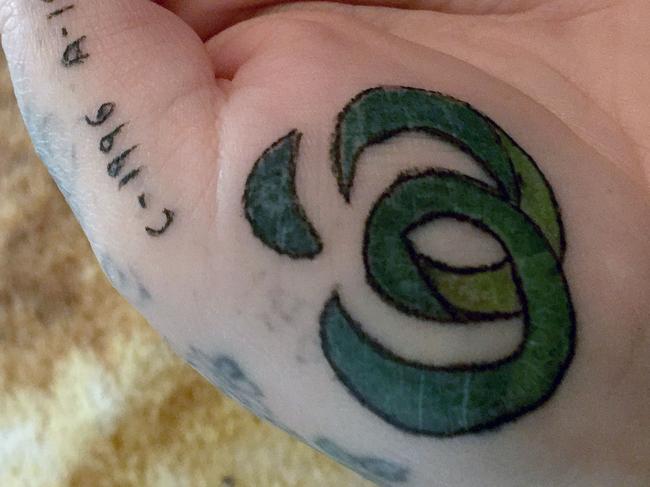 PIC FROM ELISABETE LINCOLN / Caters News - (PICTURED: Elisabete Lincoln, 43,from Hobart, Tasmania, Australia, got a tattoo of the Australian supermarket, Woolworths, tattooed on her hand last week ) - A mum has taken her supermarket obsession to the next level by getting the stores logo tattooed on her hand. Elisabete Lincoln, 43,decided to have the logo of Australian supermarket, Woolworths, tattooed on her hand last week (SEPTEMBER 13) after a lifetime of being a loyal customer.SEE CATERS COPY