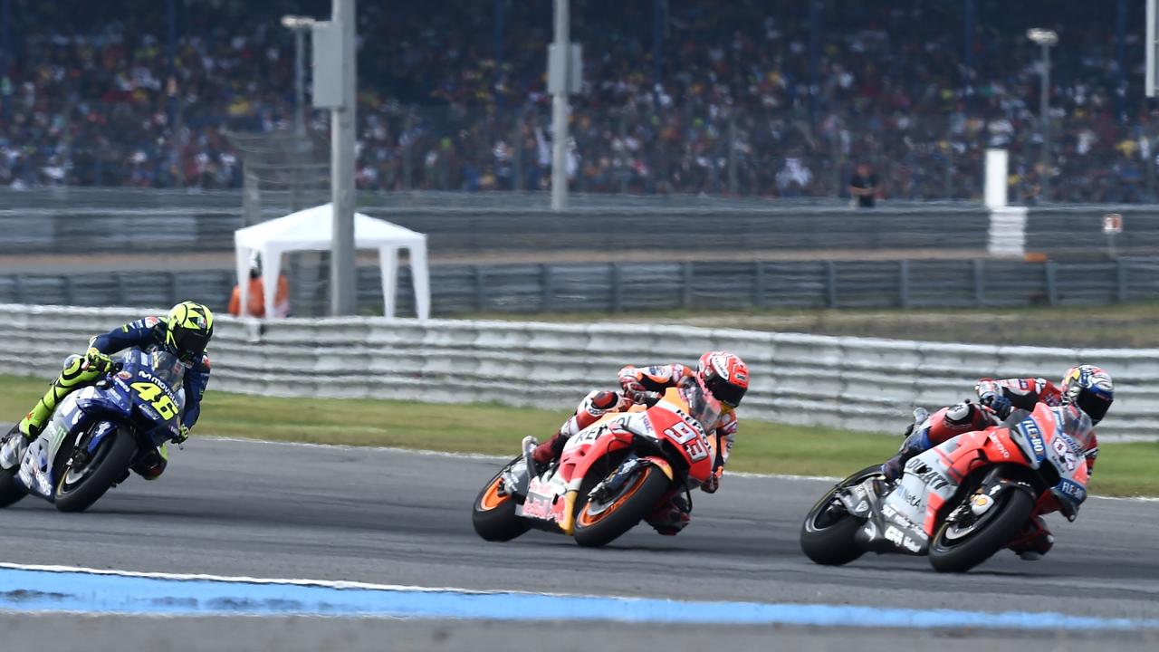 Valentino Rossi (L) chases Marc Marquez (C) and Andrea Dovizioso (R) in Buriram last year. Picture: Lillian Suwanrumpha