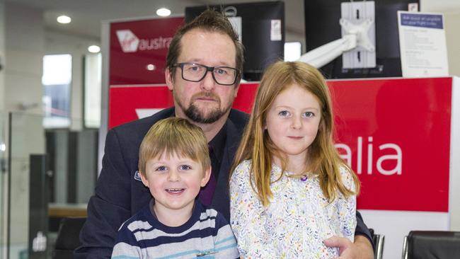 Virgin Australia ground crew member Darren Hay with his children, Farrah, 5, and Braxton, 2, after the announcement that Deloitte has been appointed as administrator for the airline. Picture: Sarah Matray