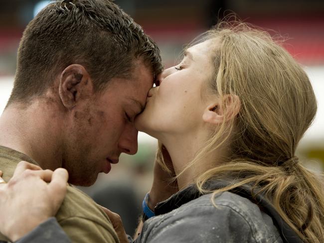 Aaron Taylor-Johnson and Elizabeth Olsen in a scene from <i>Godzilla</i>.