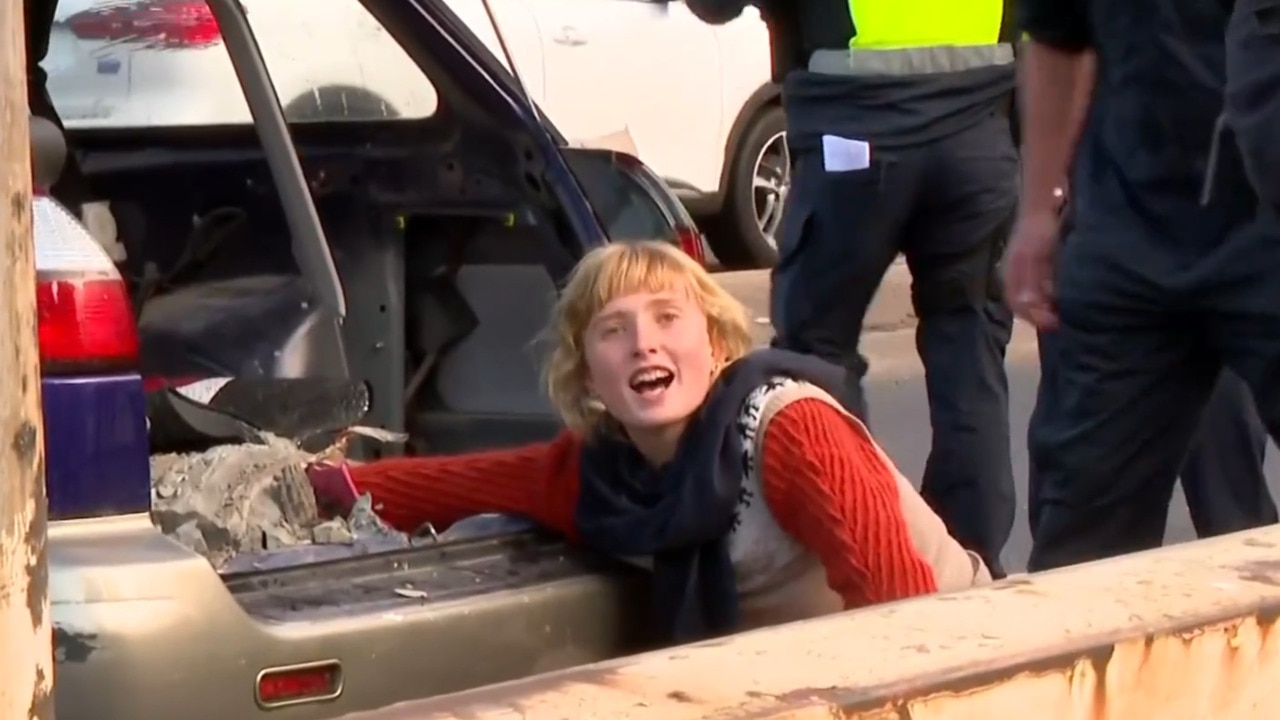 Protester cements herself into car on the last day of the Land Forces military expo