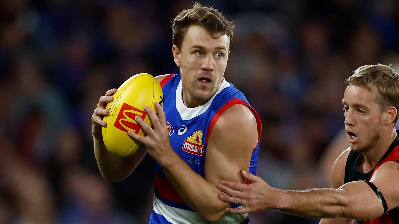 MELBOURNE, AUSTRALIA - APRIL 12: Jack Macrae of the Bulldogs and Darcy Parish of the Bombers compete for the ball during the 2024 AFL Round 05 match between the Western Bulldogs and the Essendon Bombers at Marvel Stadium on April 12, 2024 in Melbourne, Australia. (Photo by Michael Willson/AFL Photos via Getty Images)