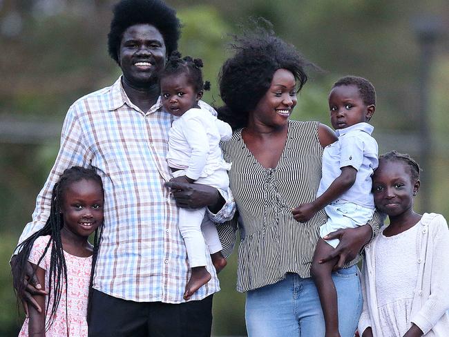 Aguek Nyok, pictured with his family, rescued trapped bus passengers from a fire. Picture: Jack Tran