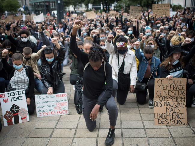 People raise their fist and stand on their knees as they demonstrate in Nantes during a 'Black Lives Matter' worldwide protests against racism and police brutality in the wake of George Floyd’s death. Picture: AFP