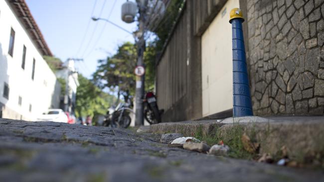 A bloody surgical glove is seen at the site where the body of Italian tourist Roberto Bardella was left by alleged traffickers at one of the entrance of the Morro dos Prazeres favela in Rio de Janeiro, Brazil, Thursday, Dec. 8, 2016. Police say Bardella was killed in a favela near the center of Brazil's Rio de Janeiro in an area fought over by rival drug trafficking gangs. Rio de Janeiro police identified the dead tourist as Bardella and said another Italian tourist named Rino Polato was found early in the day unharmed at an entrance to the Morro dos Prazeres favela. (AP Photo/Silvia Izquierdo)