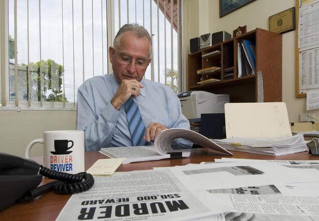 Maryborough Detective Senior Sergeant Leith Lindsay sifts through records of the unsolved murder.