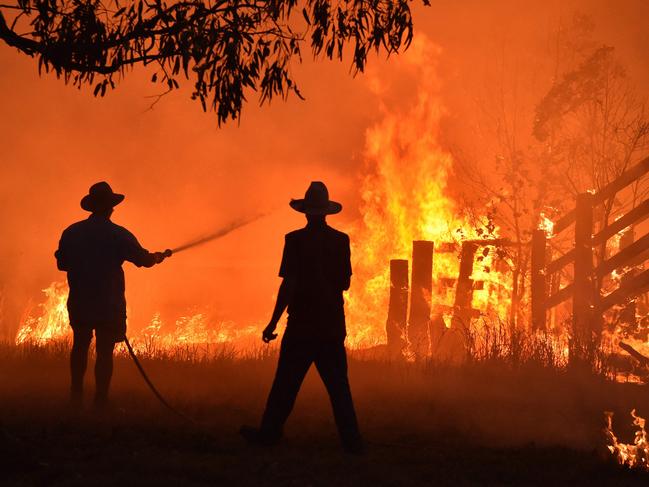 Residents defend a property from a bushfire near Taree in NSW on November 12, 2019. Picture: Peter Parks/AFP