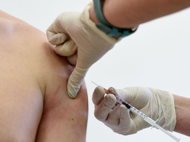 A nurse administers a measles vaccine to a teenager in the school of Lapaivka village near the western Ukrainian city of Lviv on February 21, 2019. - The mobile brigade, which consists of two pediatricians and a nurse, arrived to the Lapaivka village as part of the health ministry's special operation in this region, leading in terms of registered measles cases. A measles epidemic is still not declared in Ukraine, though in 2018 the country recorded highest number of measles cases in European region. Since the start of 2019, around 20,000 people in Ukraine have contracted this highly contagious viral disease. Nine people, including two children, have died of measles in Ukraine this year. (Photo by Yuri DYACHYSHYN / AFP)