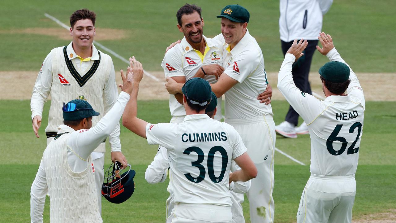 Australia's Mitchell Starc celebrates with teammates after taking the wicket of England's Harry Brook on day three. (Photo by Ian Kington / AFP)