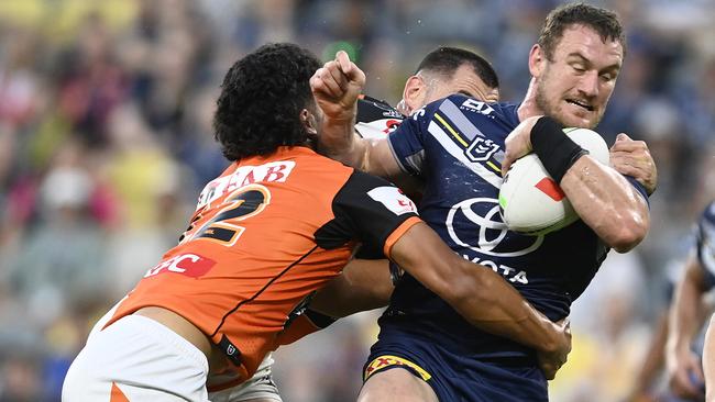 Coen Hess of the Cowboys is tackled by Shawn Blore of the Tigers during the round 18 NRL match between North Queensland Cowboys and Wests Tigers at Qld Country Bank Stadium on July 01, 2023 in Townsville, Australia. (Photo by Ian Hitchcock/Getty Images)