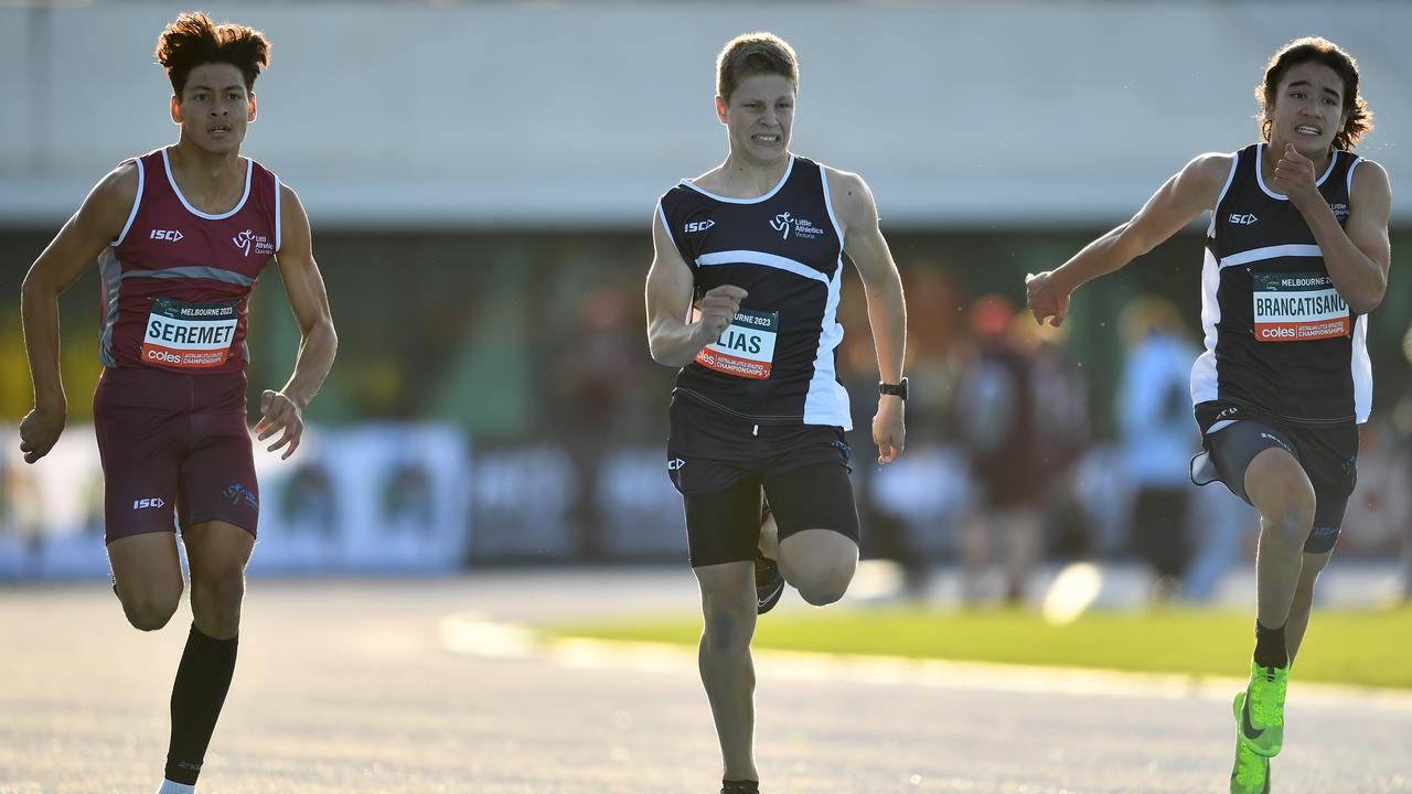 Leonardo Seremet (QLD), Matthew Milias (VIC) and Cooper Brancatisano (VIC) compete in the Boys U14 200m during the Australian Little Athletics Championships at Lakeside Stadium in Albert Park, Victoria on April 22, 2023.