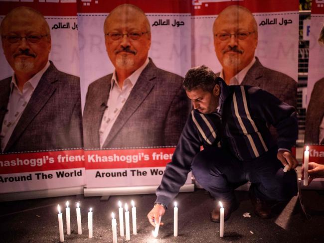 A man lights candles in a tribute to Jamal Khashoggi. Photo: AFP