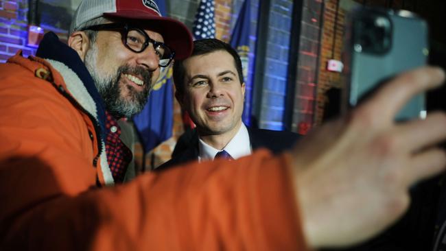 Pete Buttigieg poses for a selfie with a supporter in New Hampshre. Picture: AFP.