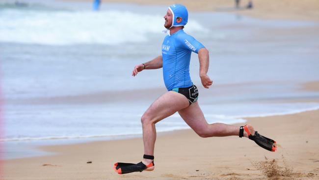 A competitor dashes into the water. Picture: Angelo Velardo