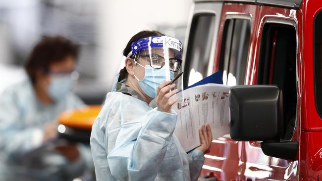 A member of the Australian Defence Force administering a COVID-19 test at the Melbourne Showgrounds. Picture: Getty