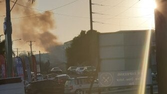 Smoke billows from a fire on Spendelove Ave in Southport. Picture: Jasmin Wheeler.