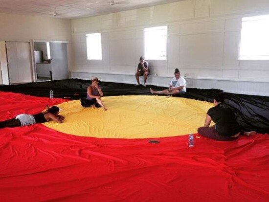 Indigenous rights supporters in Brisbane hand-sew a huge Stolenwealth Games protest flag ahead of their Stolenwealth Games protest on the Gold Coast. Picture: Instagram.