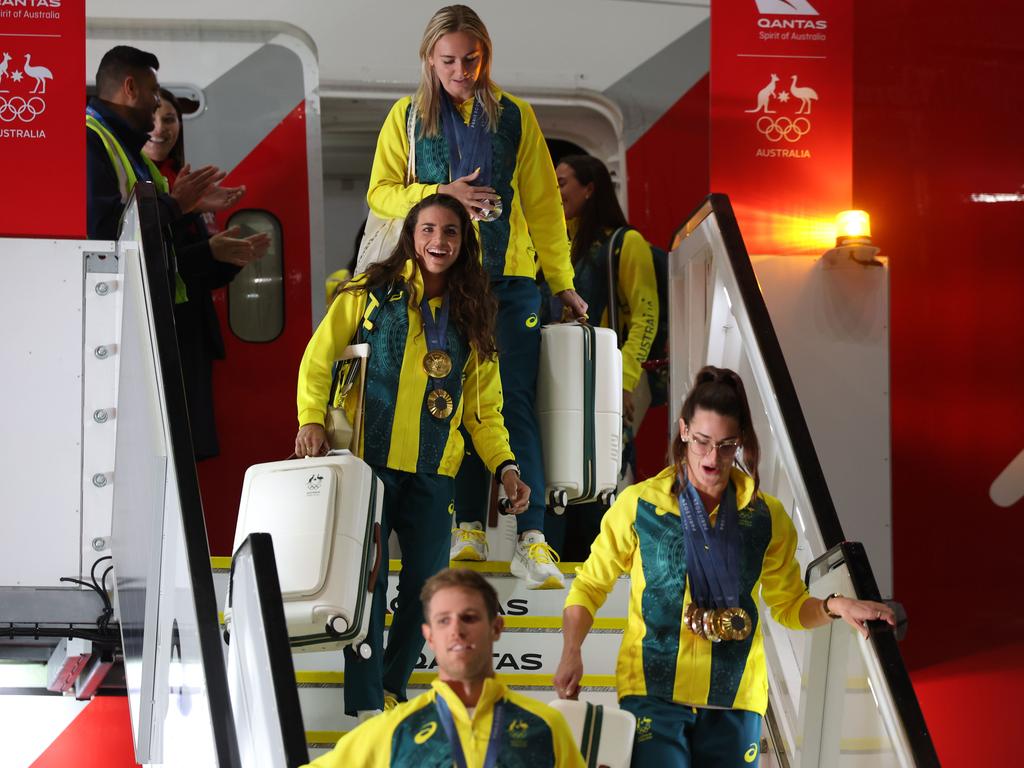 From the top, Ariarne Titmus, Jess Fox, Kaylee McKeown and Matt Wearn step off the charter flight in Sydney. Picture: Rohan Kelly