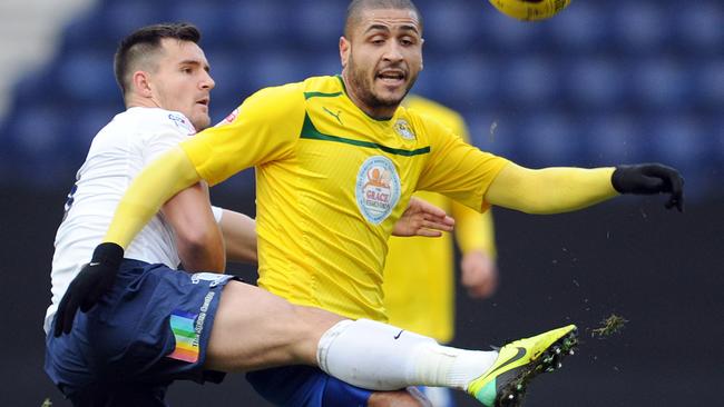 Preston North End's Bailey Wright tackles Coventry City's Leon Clarke.