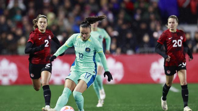 Cloe Lacasse #20 and Sydney Collins #2 of Canada look on as Amy Sayer #17 of Australia plays the ball during the first half of their friendly match at Starlight Stadium on December 01, 2023 in Langford, British Columbia. (Photo by Jeff Vinnick/Getty Images for Football Australia)