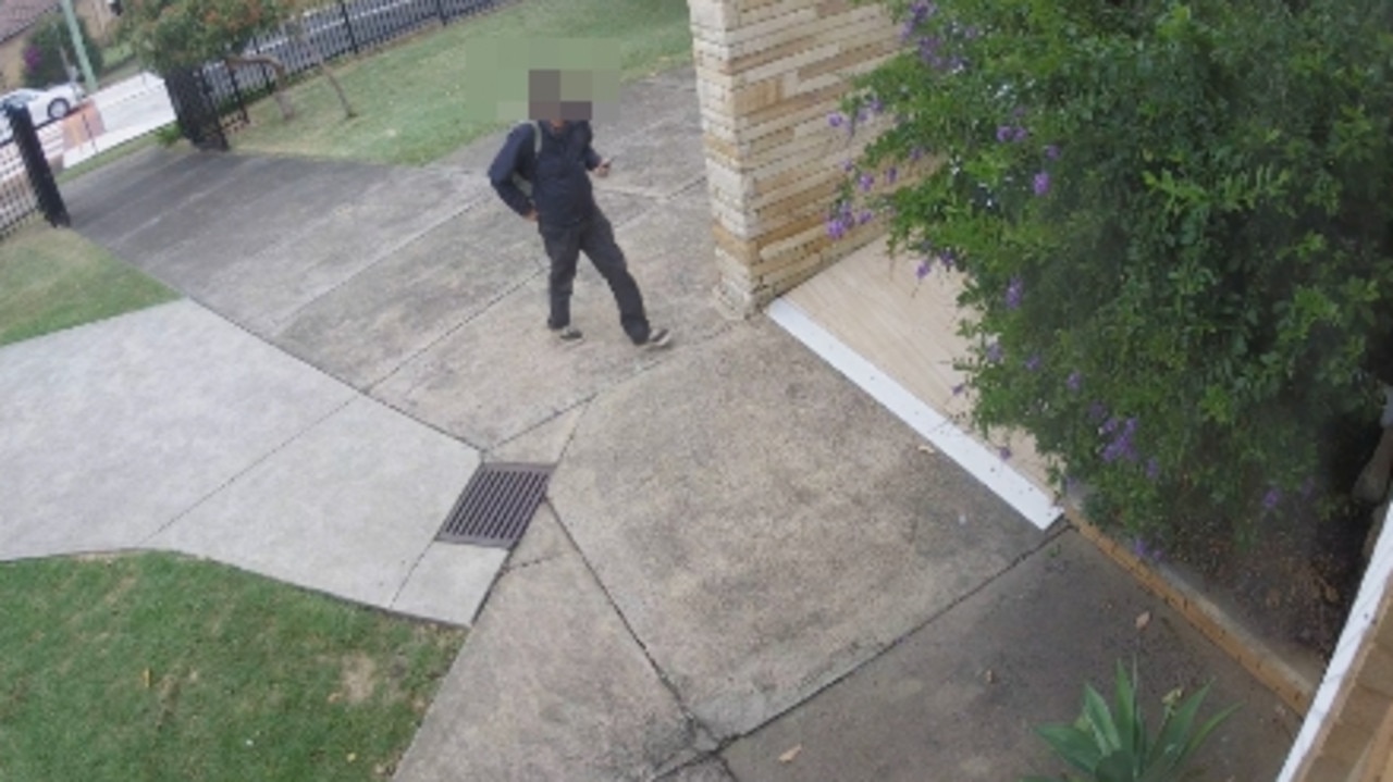 A man about to burst into St Bernadette's Catholic Church at Dundas Valley on April 21.