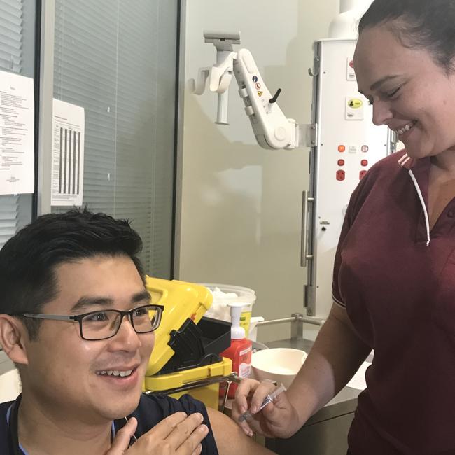 Cairns Hospital's Alfred Lui receives his flu jab from nurse Nicole Sporne. Photo: Daniel Bateman