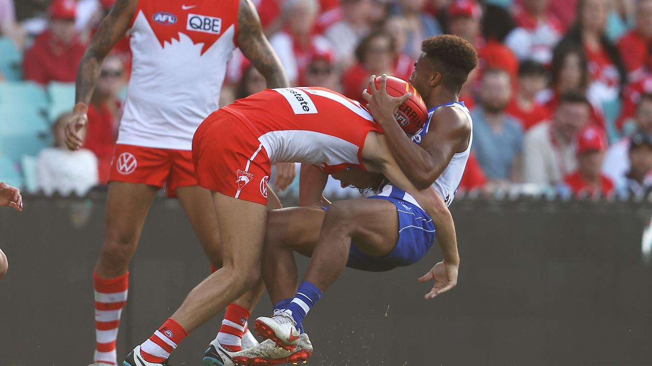 North Melbourne’s Atu Bosenavulagi is hit by a strong Sydney tackle. Picture: Mark Kolbe/Getty Images