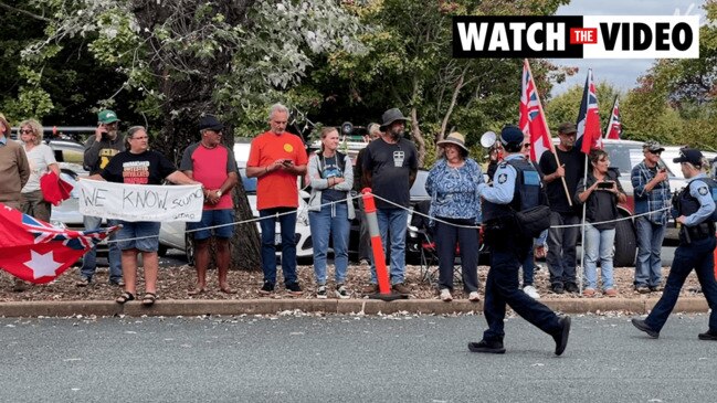 Protestors wait for the PM outside the gates of Government House