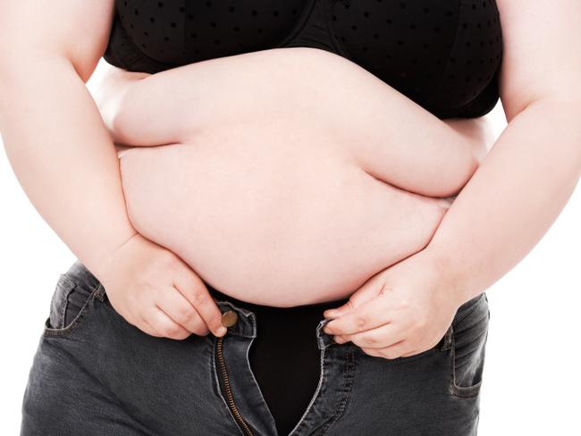 RendezView. Overweight woman trying desperately to fit into a pair of jeans that are too small. (Pic: iStock)