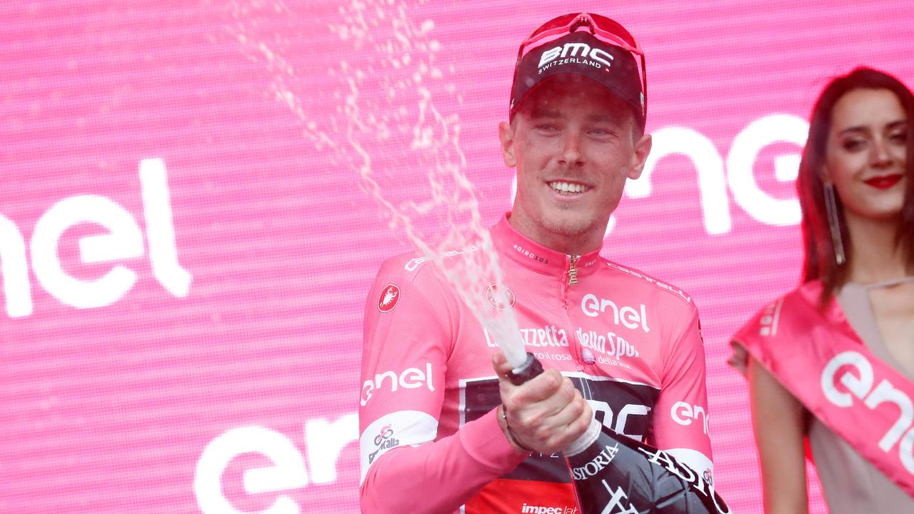 Australia's rider of team BMC Rohan Dennis wearing the overall leader's pink jersey celebrates on the podium after the 3rd stage of the 101st Giro d'Italia.