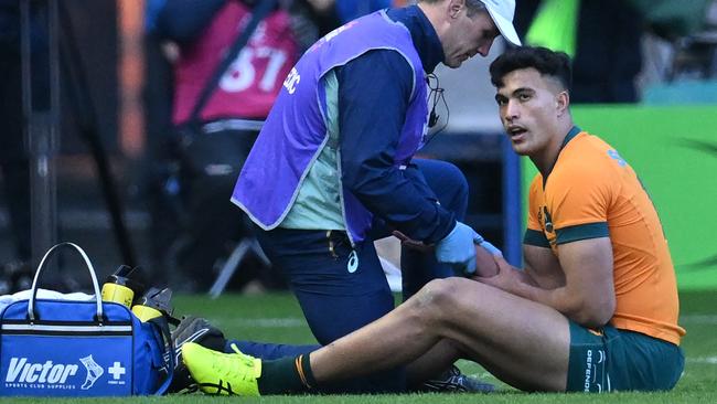 Australia's centre Joseph-Aukuso Suaalii is treated by medical staff after being hurt in a collision with Scotland's centre Sione Tuipulotu (not pictured) during the Autumn Nations Series International rugby union test match between Scotland and Australia at Murrayfield Stadium in Edinburgh on November 24, 2024. (Photo by ANDY BUCHANAN / AFP)