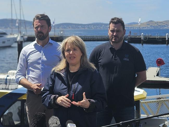 Liberal Senator Jonno Duniam, Environment Minister Madeleine Ogilvie and Salmon Tasmania CEO Luke Martin speak to the media on the Hobart waterfront on Thursday, January 9, 2025.