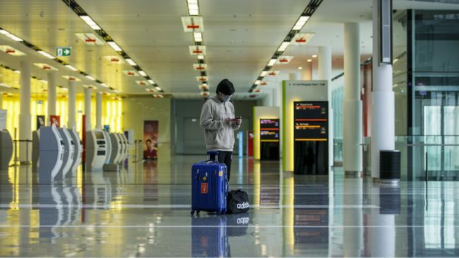 Marvel Wijaya, 19, a university student from Indonesia at Canberra Airport awaiting a flight to Sydney. Fewer than 100 people a day are using the terminal in Australia’s national capital as travel restrictions continue. Picture: Sean Davey.