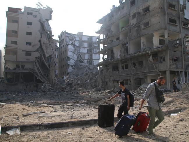 2023 Year in Review - NEWS GAZA CITY, GAZA - OCTOBER 10: Palestinian citizens evacuate their homes damaged by Israeli airstrikes on October 10, 2023 in Gaza City, Gaza. Almost 800 people have died in Gaza, and 187, 000 displaced, after Israel launched sustained retaliatory air strikes after a large-scale attack by Hamas. On October 7, the Palestinian militant group Hamas launched a surprise attack on Israel from Gaza by land, sea, and air, killing 1000 people and wounding more than 2000. Israeli soldiers and civilians have also been taken hostage by Hamas and moved into Gaza. The attack prompted a declaration of war by Israeli Prime Minister Benjamin Netanyahu. (Photo by Ahmad Hasaballah/Getty Images)