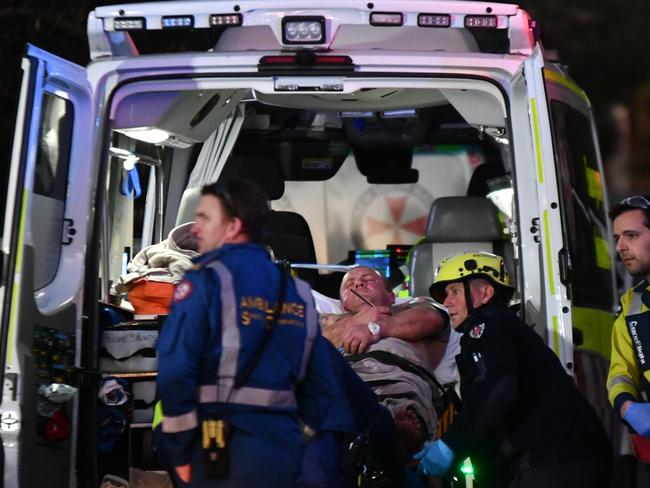 John Dunne is put into an ambulance at Avalon. Picture: Sebastien Dekker